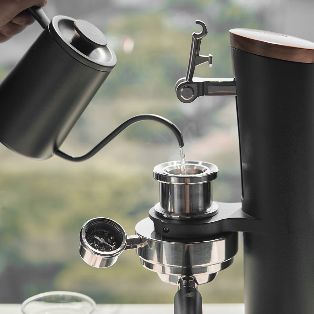 Filling-the-IKAPE-hand-cranked-coffee-machine-with-water